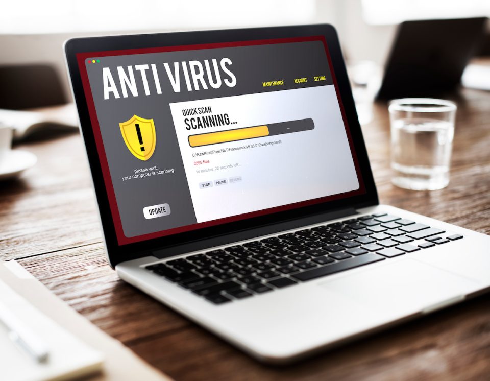 Laptop screen showing antivirus scanning for malware removal